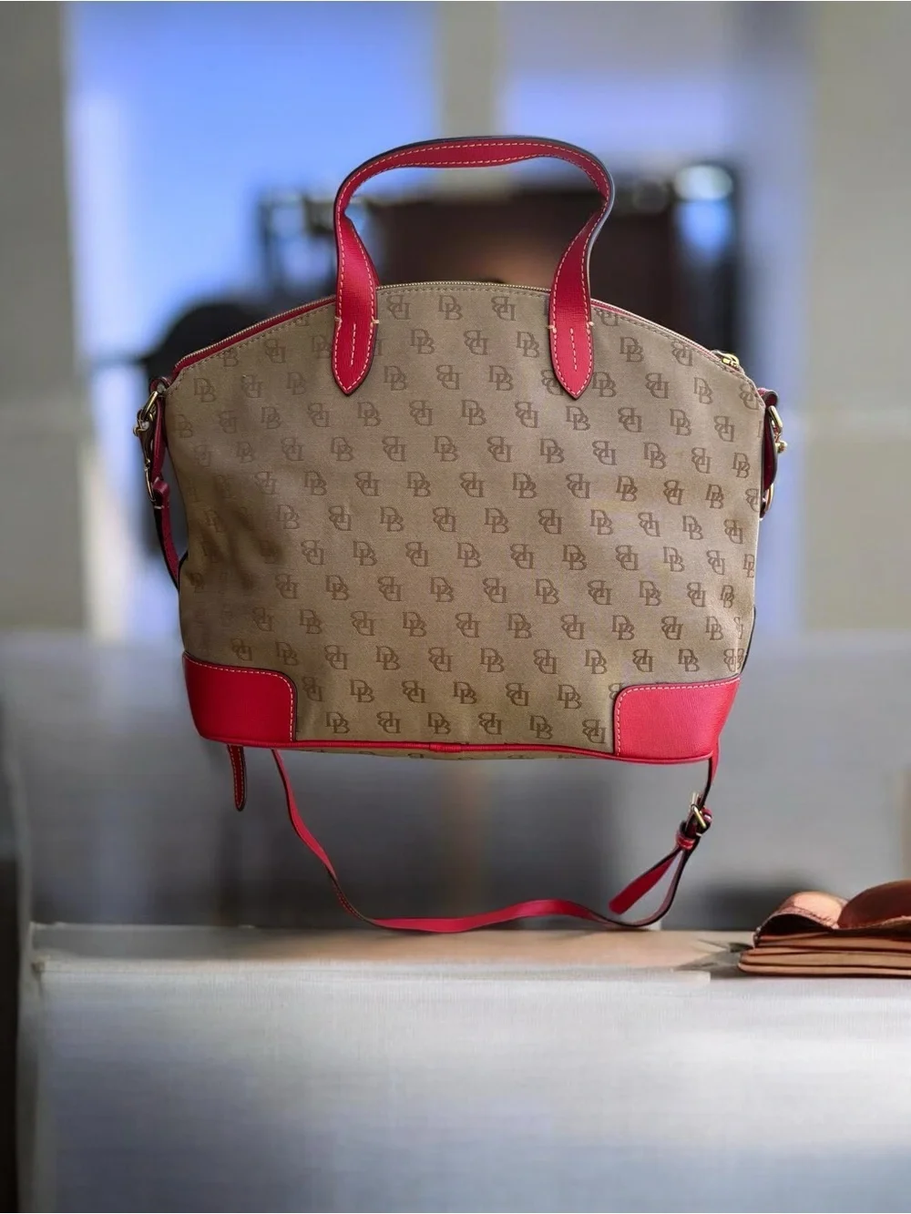 Dooney & Bourke Signature monogram satchel features vibrant pink leather trim
